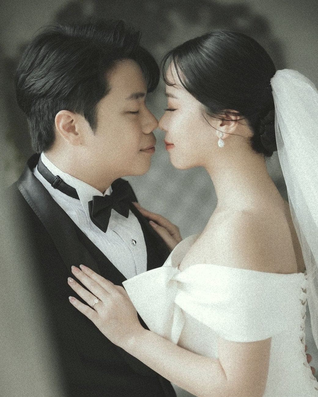 Witita and Sorratat, forehead to forehead in tuxedo and gown